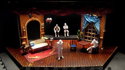 Picture of the model that set designer Daniel Pinha created, depicting a "theater in the round" and the English manor house setting for the play within a play. It concentrates more on architectural elements and the furniture.